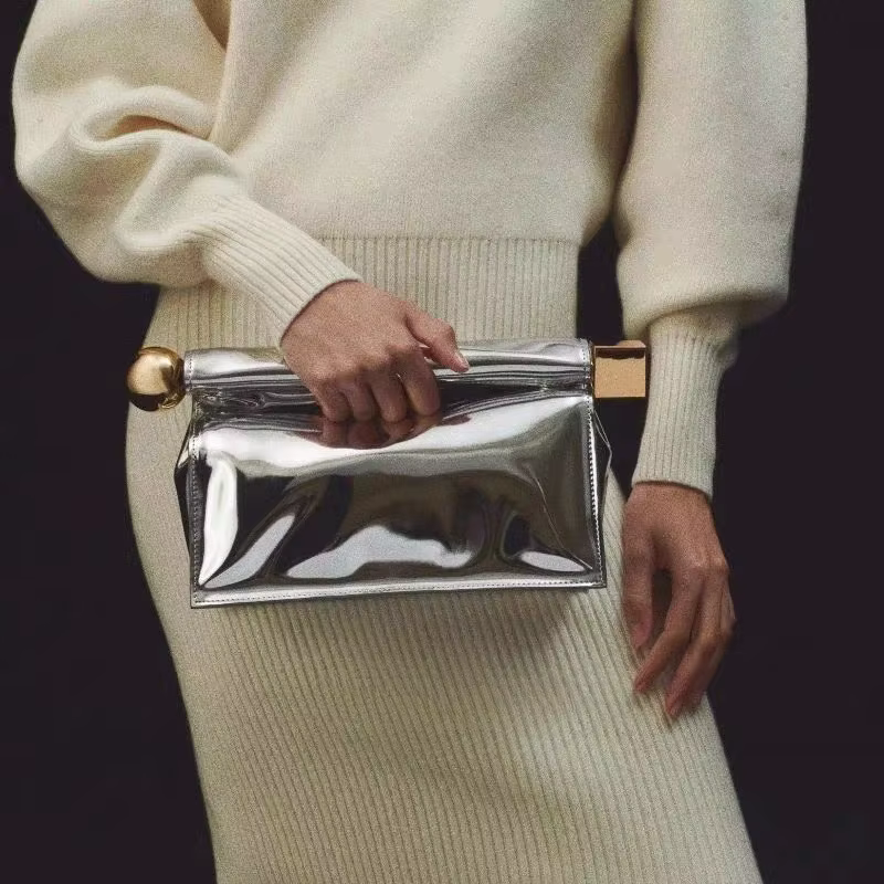 Un nouveau sac d'embrayage enroulé de luxe, à la mode et de niche pour femmes, un sac à bandoulière polyvalent à chaîne pliante à une épaule